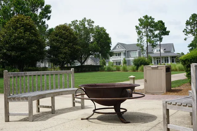 a view of a chairs and table in the back yard