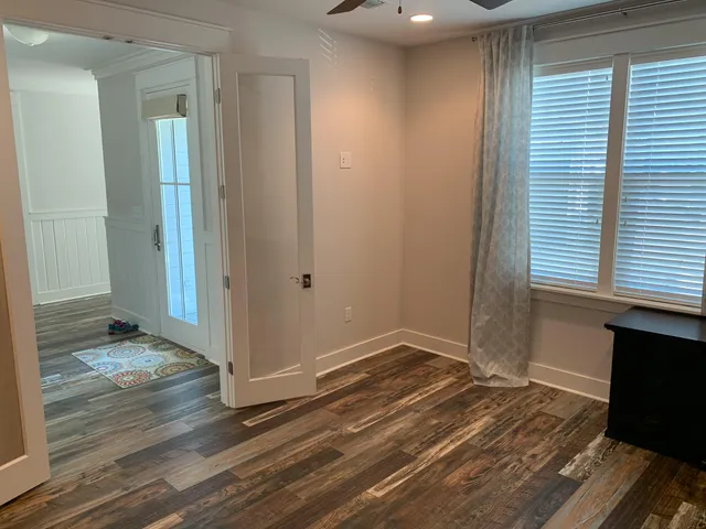 a view of a room with wooden floor and a window