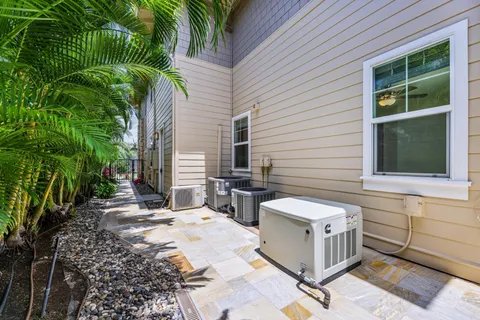 a view of backyard with outdoor seating and plants