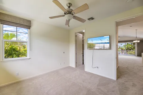 an empty room with closet and windows
