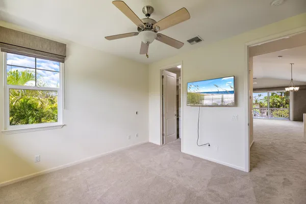 an empty room with closet and windows