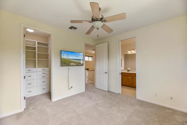 a view of walk in closet with empty racks