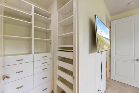 a view of a hallway with a living room