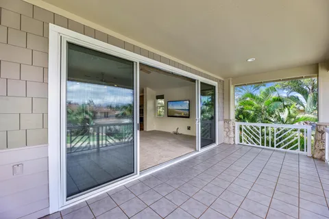 a living room with stainless steel appliances kitchen island furniture and a chandelier
