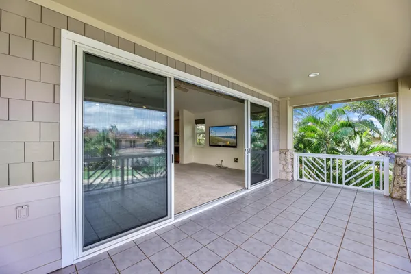 a living room with stainless steel appliances kitchen island furniture and a chandelier