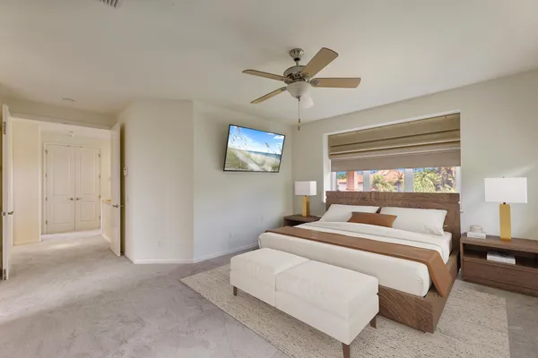 a bedroom with a large bed and a window