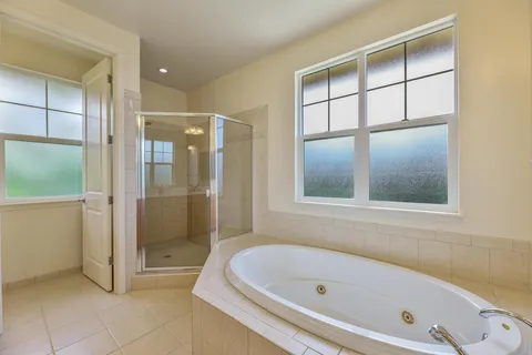 a bathroom with a tub a shower and a sink