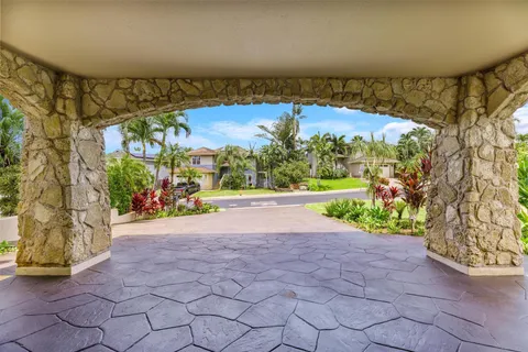 a view of entryway with a yard and potted plants