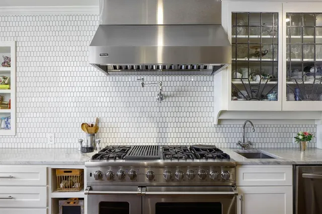 a stove sitting inside of a kitchen