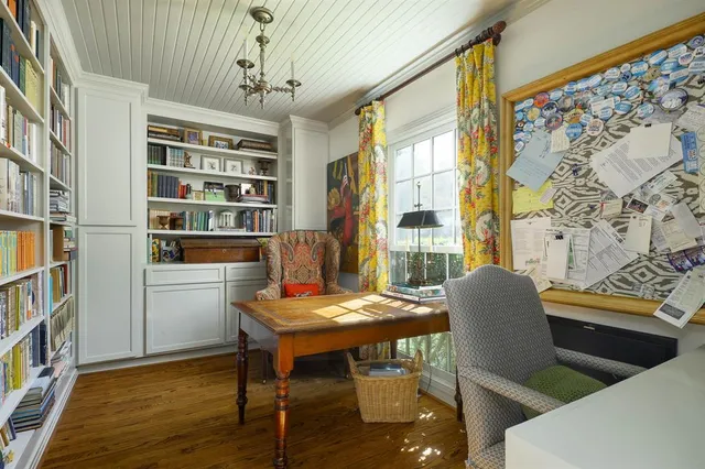 a view of a dining room with furniture and a book shelf
