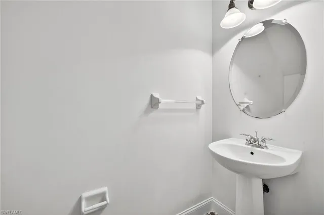 a bathroom with a sink and mirror