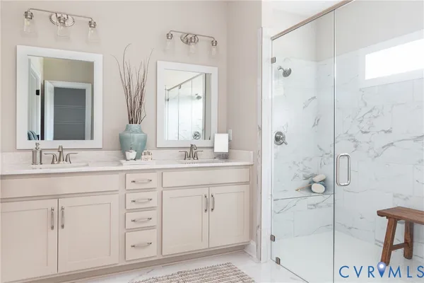 a bathroom with a shower sink and mirror