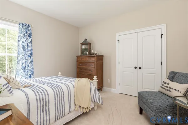 a bedroom with a bed and a couch
