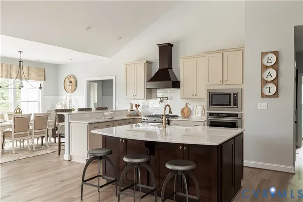 a kitchen with granite countertop a sink stove and cabinets