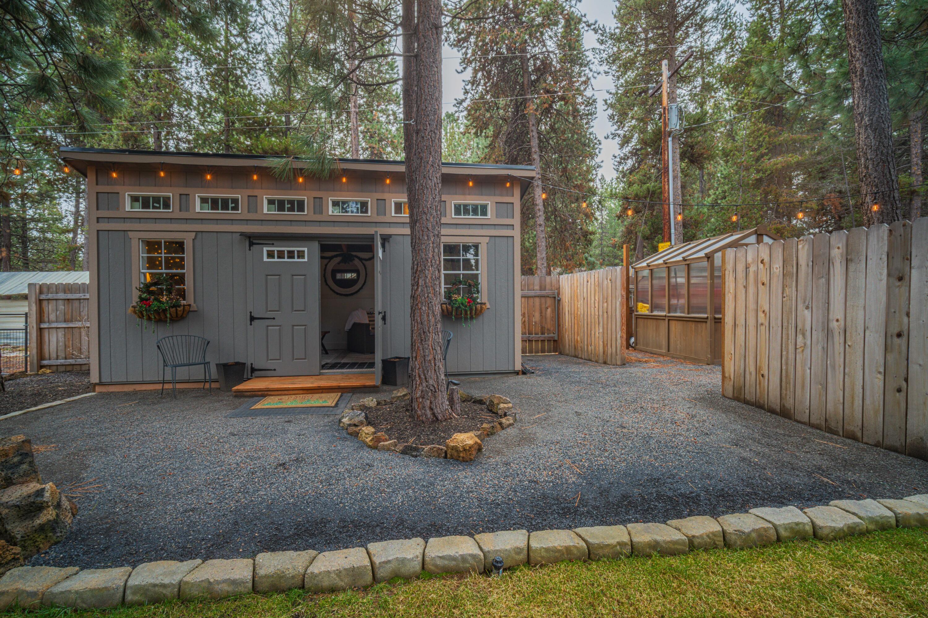 16927 Covina Road Bend, OR 97707 - Photo 41 of 54 Finished backyard outbuilding and greenhouse area add versatility and charm to the property, offering flexible bonus space and garden potential in a beautifully designed setting.