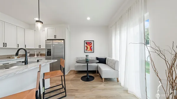 a living room with furniture a rug and white walls