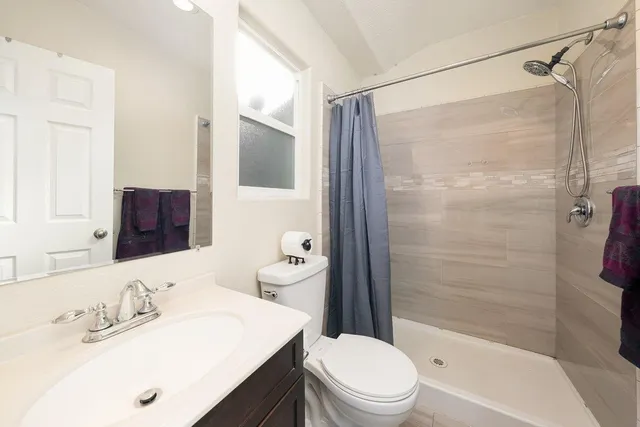 a bathroom with a sink double vanity granite and a mirror