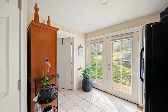 a front view of a house with a yard and tree s