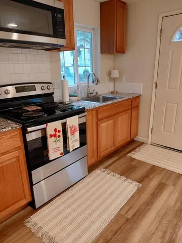 a view of a house with backyard sitting area and roof