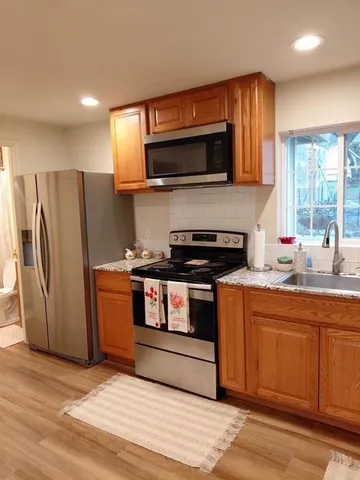 a view of a patio with a table and chairs under an umbrella