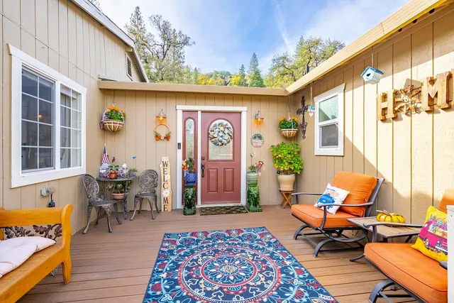 a open kitchen with stainless steel appliances kitchen island granite countertop a refrigerator a stove top oven and a sink with cabinets