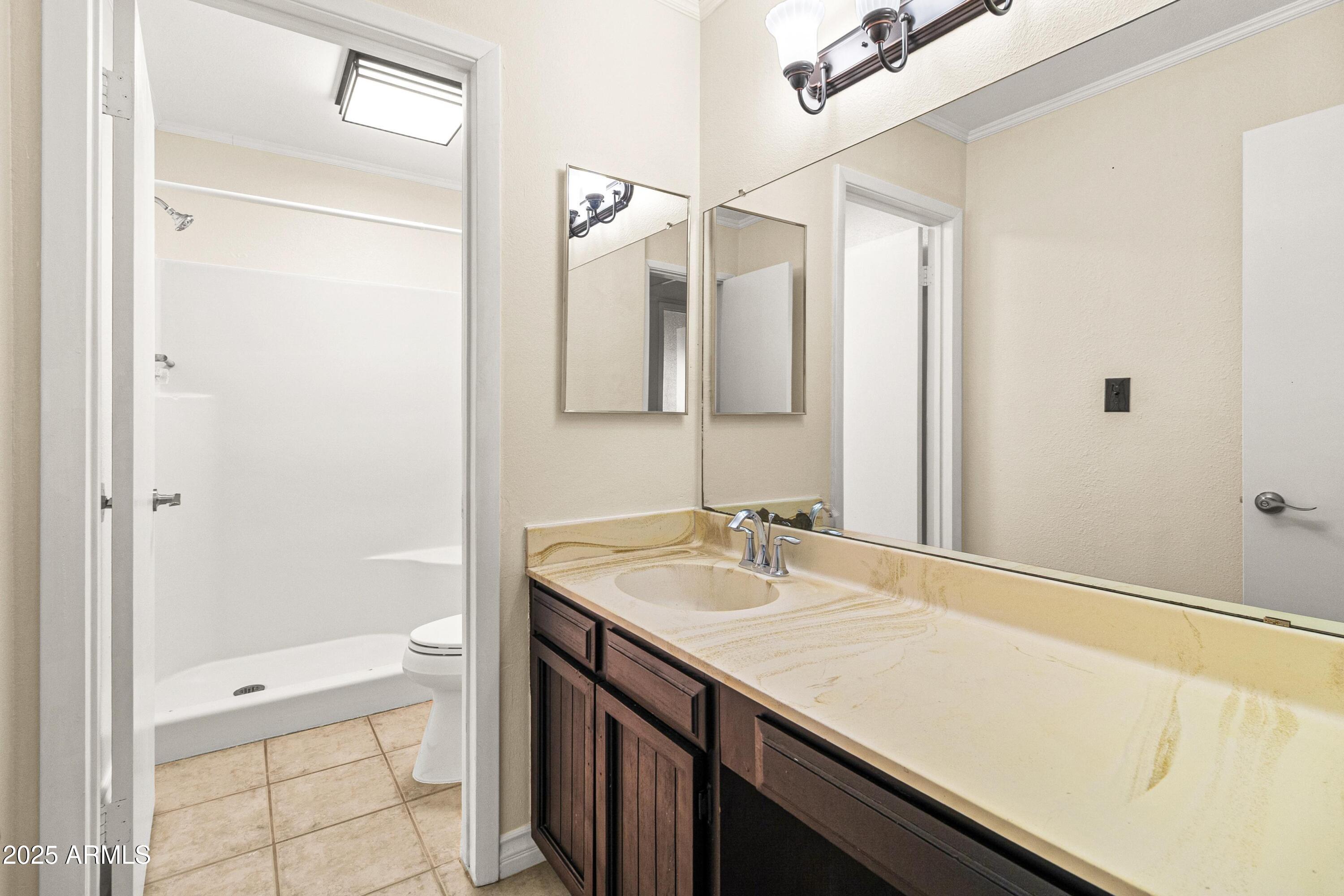 2846 West Villa Rita Drive Phoenix, AZ 85053 - Photo 18 of 24 a bathroom with a sink and a mirror