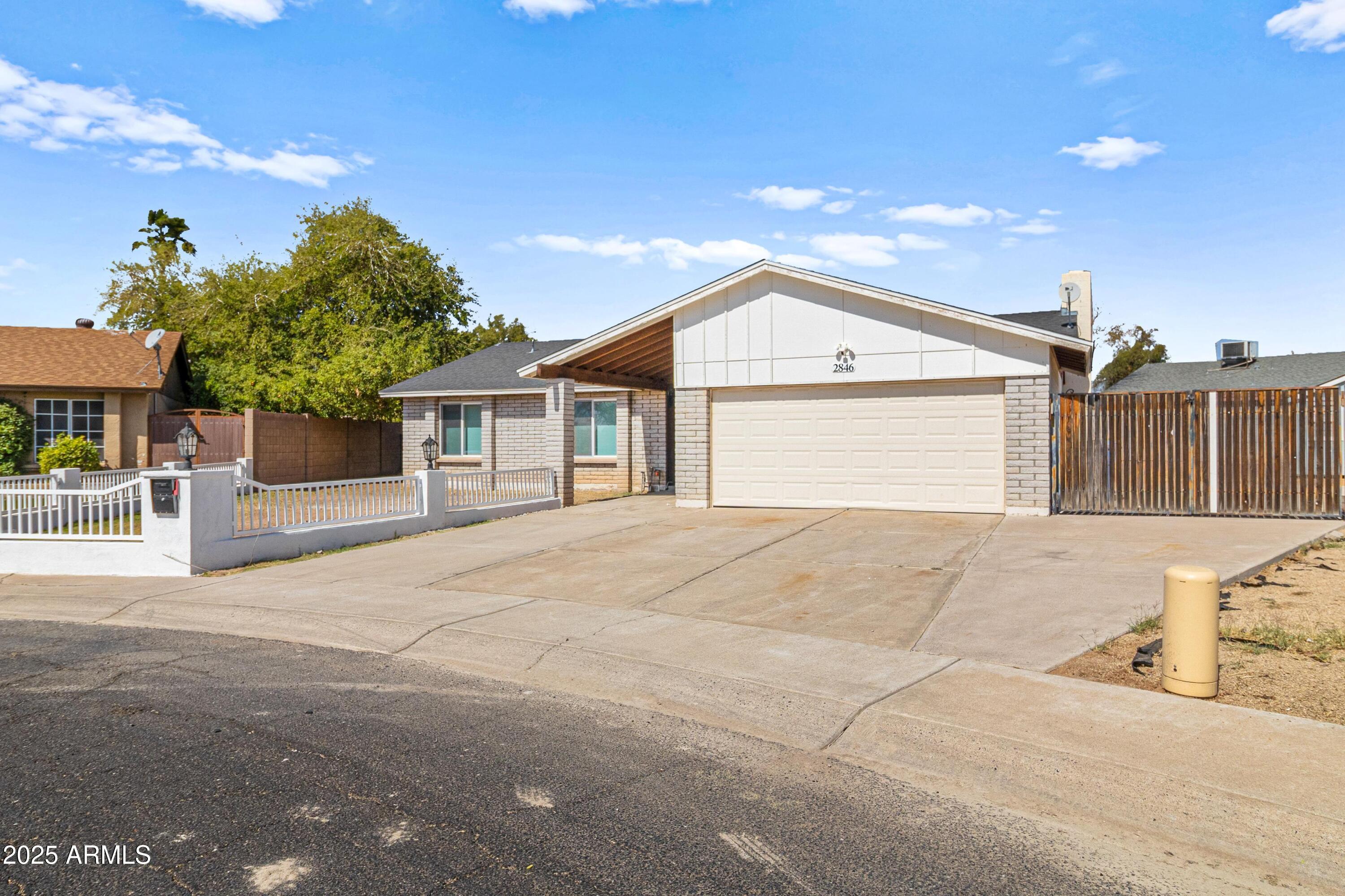 2846 West Villa Rita Drive Phoenix, AZ 85053 - Photo 2 of 24 a front view of a house with a yard and garage