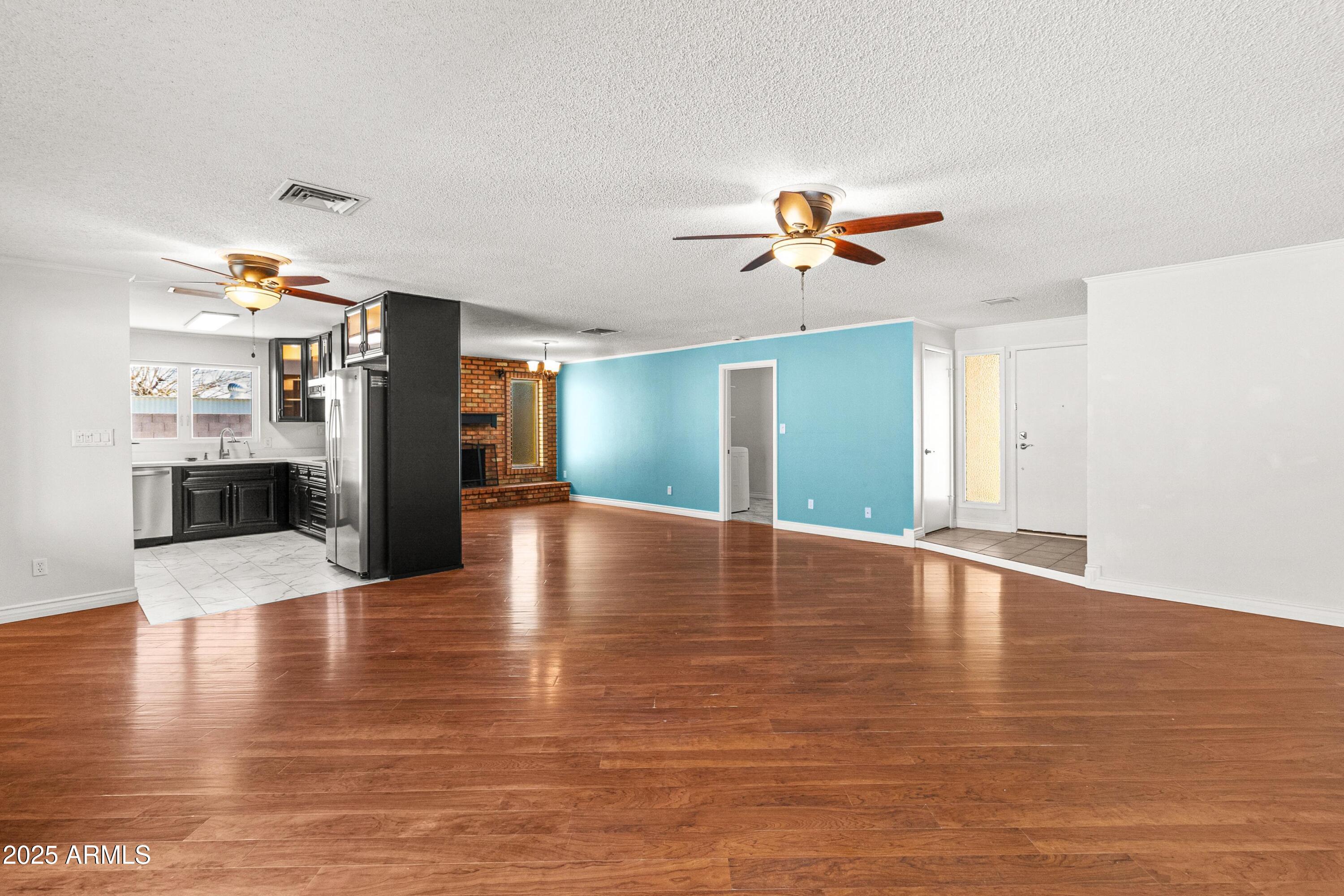 2846 West Villa Rita Drive Phoenix, AZ 85053 - Photo 4 of 24 a view of an empty room with window and wooden floor