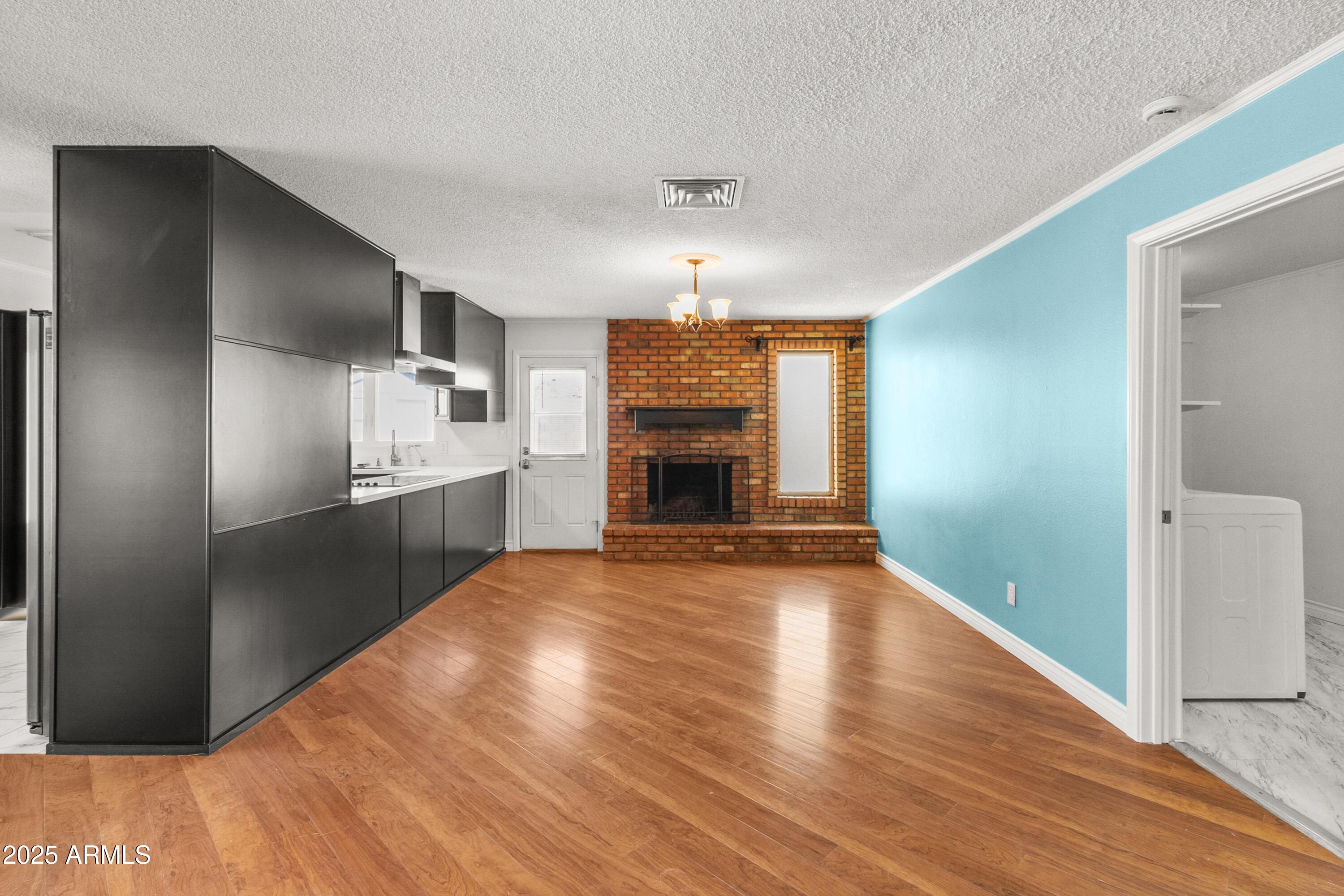 2846 West Villa Rita Drive Phoenix, AZ 85053 - Photo 5 of 24 a view of a kitchen with wooden floor and a ceiling fan