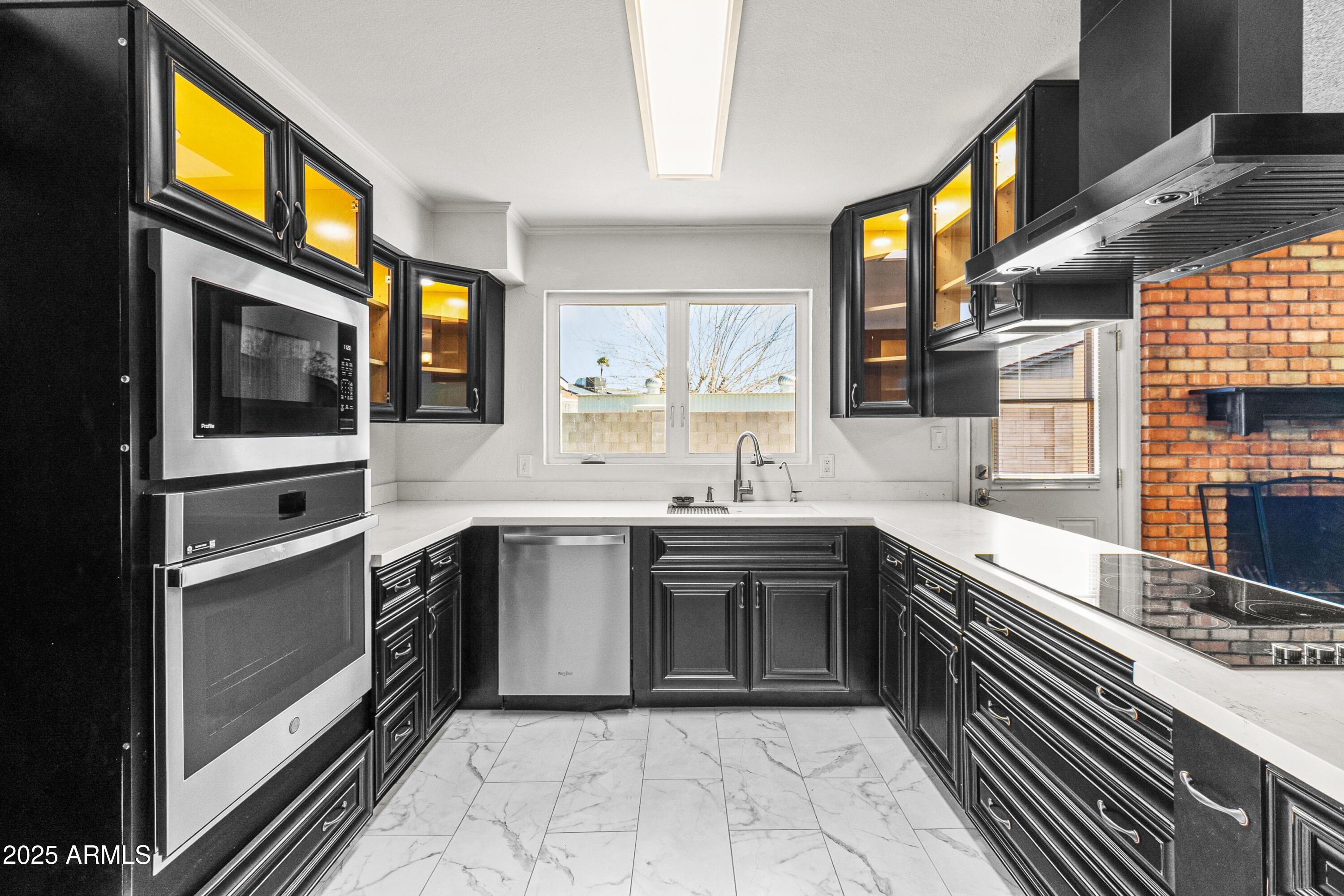 2846 West Villa Rita Drive Phoenix, AZ 85053 - Photo 6 of 24 a kitchen with stainless steel appliances granite countertop a sink and cabinets
