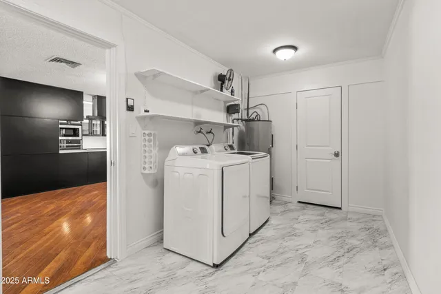 a utility room with cabinets washer and dryer