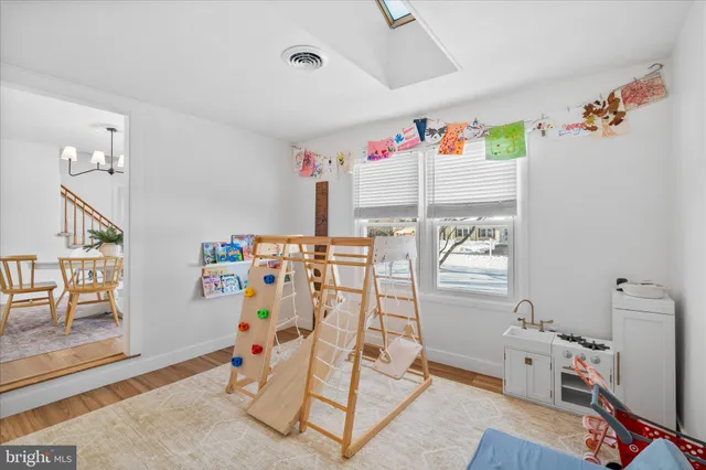 a kitchen with stainless steel appliances granite countertop a refrigerator a stove a sink dishwasher and white cabinets with wooden floor