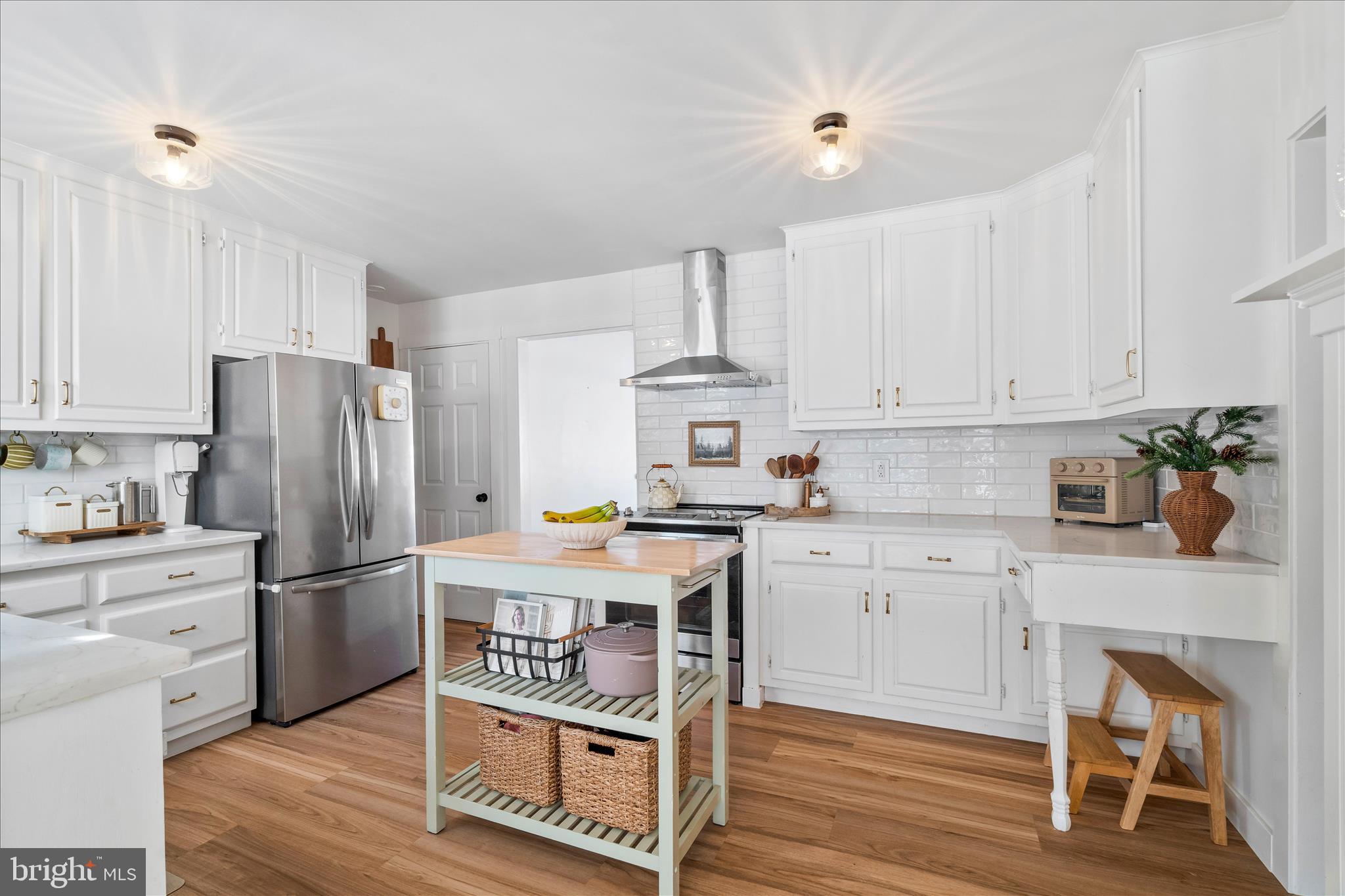 7997 Pleasant Court Frederick, MD 21701 - Photo 17 of 78 a kitchen with stainless steel appliances granite countertop a refrigerator a stove a sink dishwasher and white cabinets with wooden floor