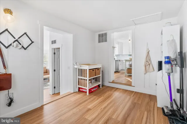 a living room with furniture a flat screen tv and a window