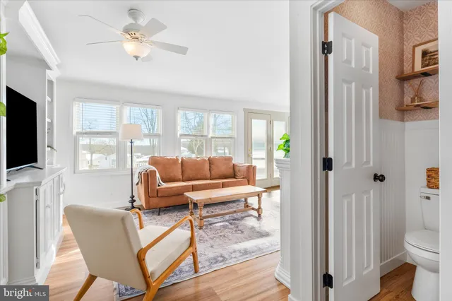 a bedroom with a flat screen tv on dresser and a flat screen tv