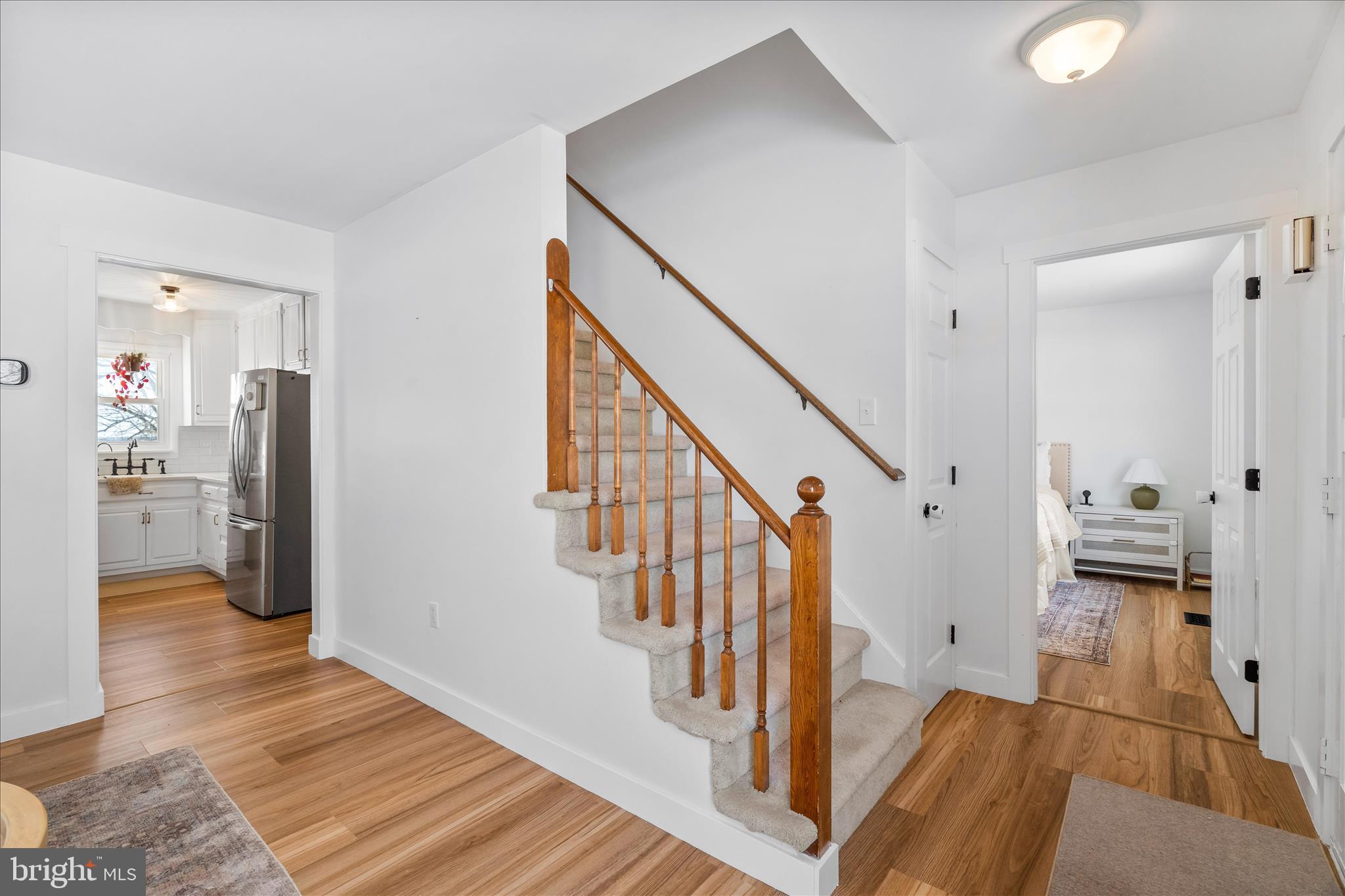 7997 Pleasant Court Frederick, MD 21701 - Photo 27 of 78 a view of a hallway view with wooden floor and staircase
