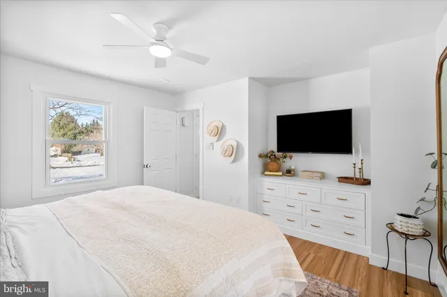 a view of a livingroom with wooden floor and a sink