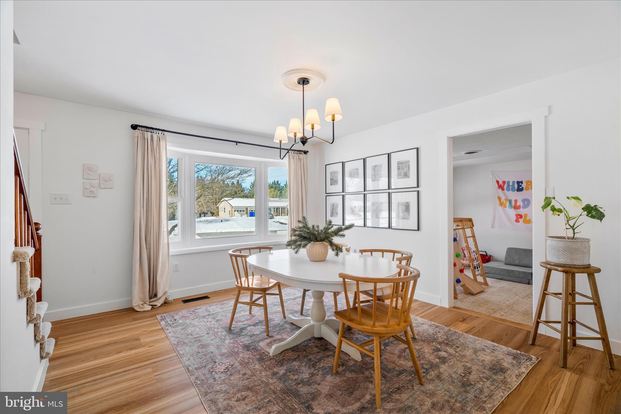 7997 Pleasant Court Frederick, MD 21701 - Photo 10 of 78 a dining room with wooden floor a chandelier a wooden table and chairs