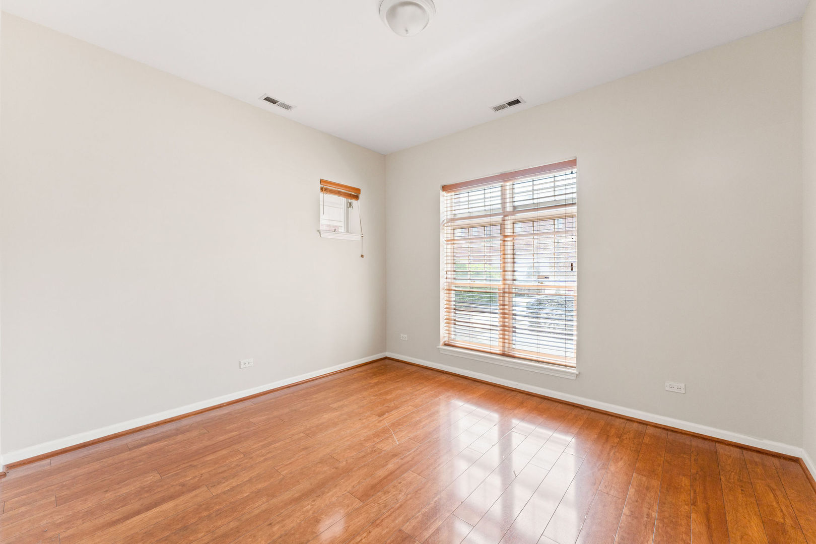 1406 South Halsted Street, Unit 1A Chicago, IL 60607 - Photo 15 of 25 an empty room with wooden floor and windows