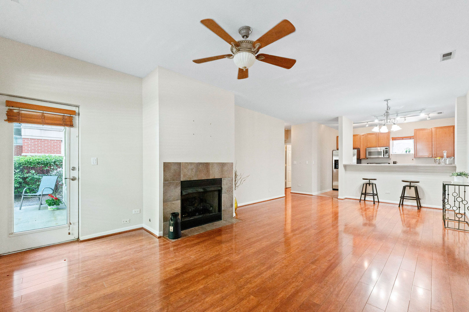 1406 South Halsted Street, Unit 1A Chicago, IL 60607 - Photo 3 of 25 a view of a livingroom with a kitchen and a fireplace
