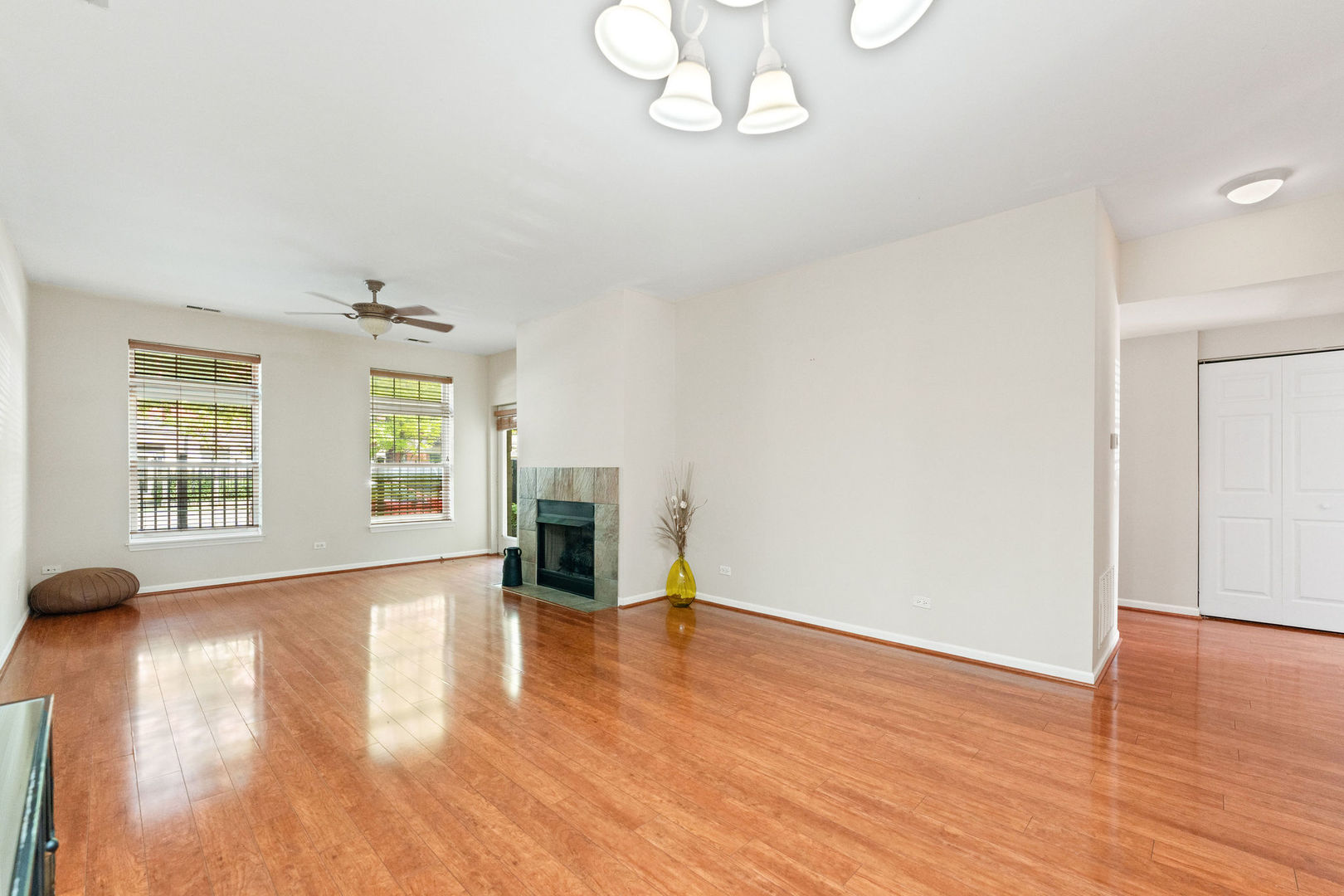 1406 South Halsted Street, Unit 1A Chicago, IL 60607 - Photo 4 of 25 an empty room with wooden floor chandelier and windows