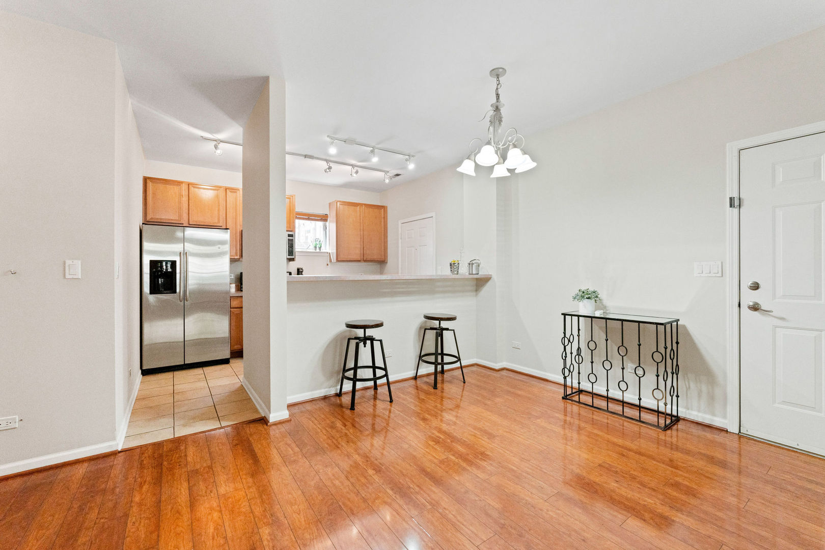 1406 South Halsted Street, Unit 1A Chicago, IL 60607 - Photo 5 of 25 an empty room with wooden floor and windows
