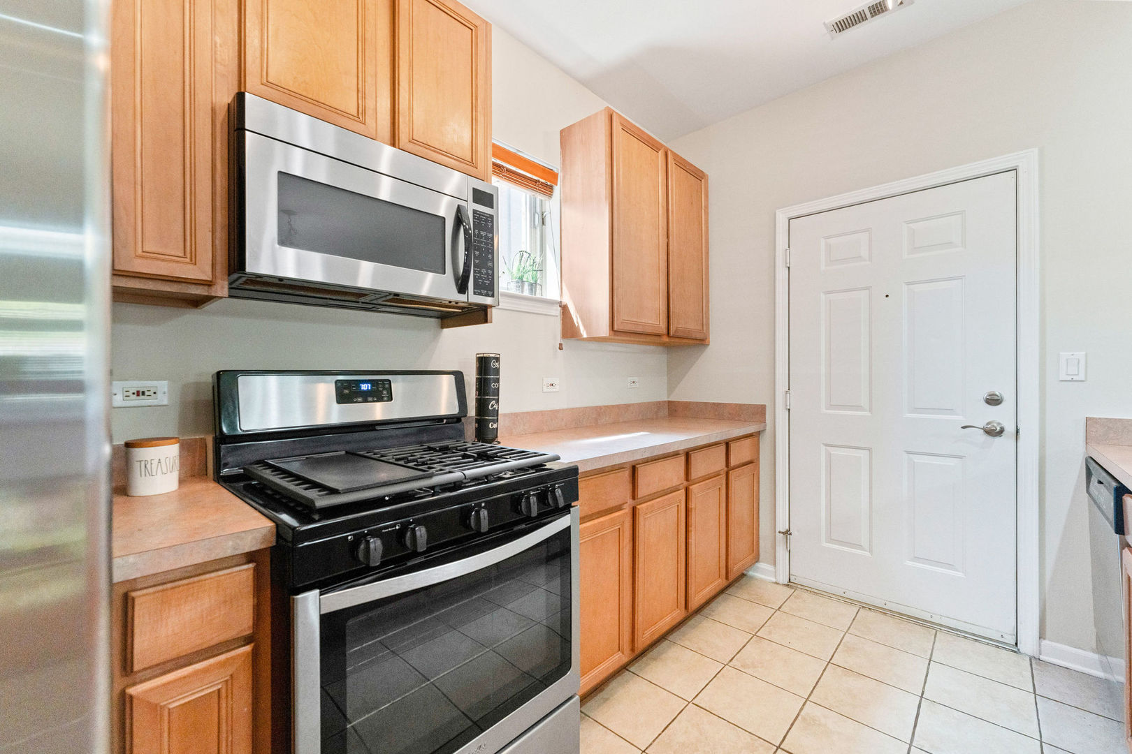 1406 South Halsted Street, Unit 1A Chicago, IL 60607 - Photo 7 of 25 a kitchen with stainless steel appliances granite countertop a stove microwave and sink
