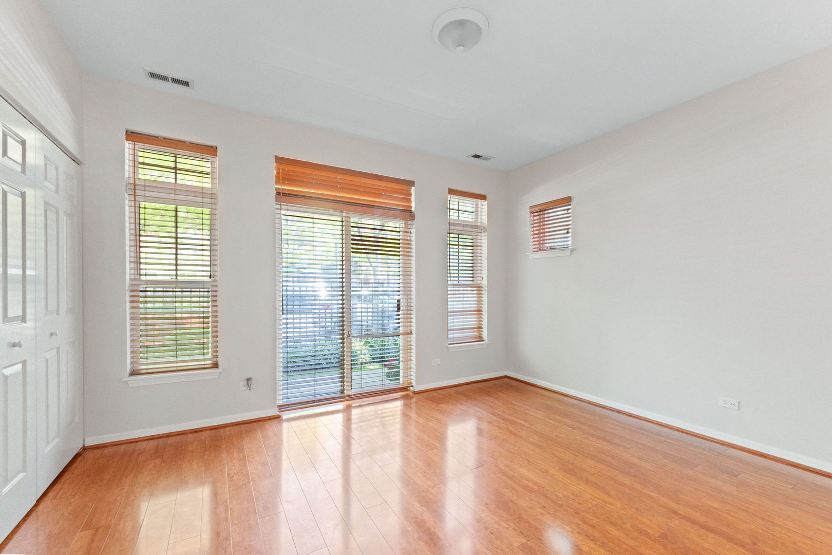 1406 South Halsted Street, Unit 1A Chicago, IL 60607 - Photo 9 of 25 an empty room with wooden floor and windows