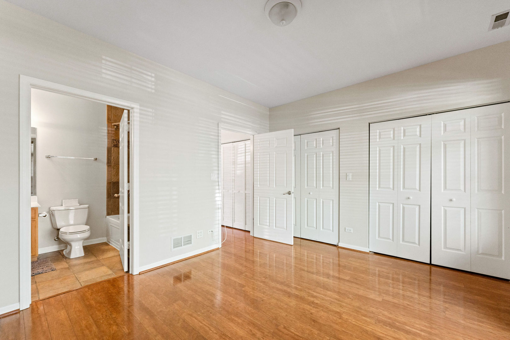 1406 South Halsted Street, Unit 1A Chicago, IL 60607 - Photo 10 of 25 a view of a room with wooden floor and a bathroom