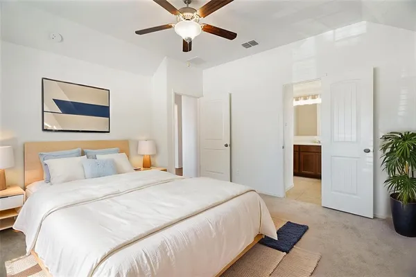 a bedroom with a bed and a chandelier