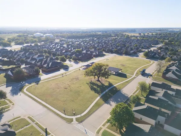 an aerial view of residential houses with outdoor space