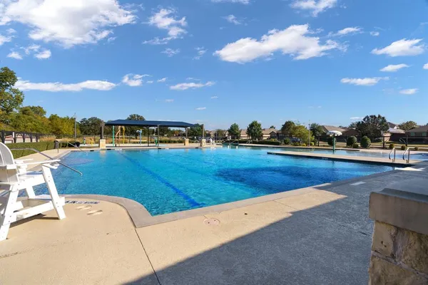 a view of a swimming pool and an outdoor seating