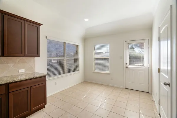 a view of an empty room with a kitchen