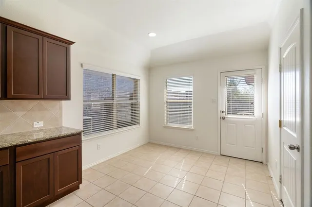 a view of an empty room with a kitchen